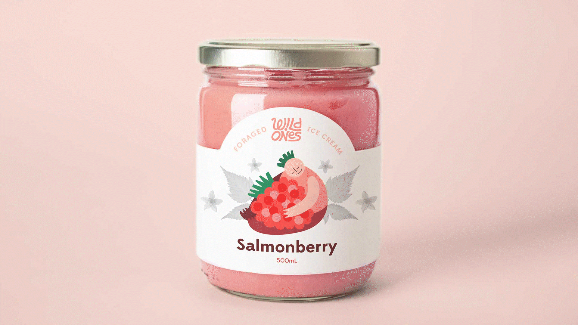 An image of ice cream packaging on a glass jar of pink salmonberry flavoured ice cream. The packaging has black and white images of salmonberry leaves and flowers, and an illustration of a sprite hugging a salmonberry.