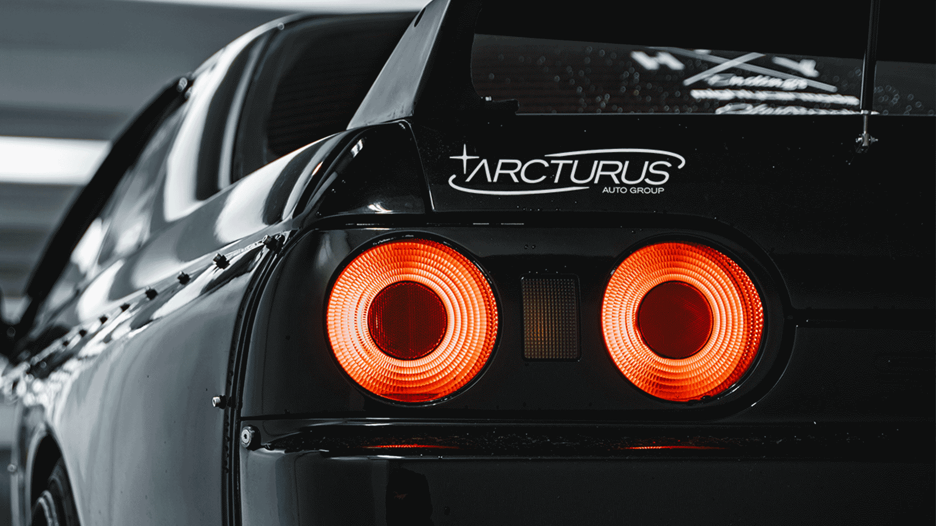 A GIF showing a mock-up of a Nissan R32 GTR with an Arcturus sticker on the left rear, and a mock-up of front and rear windshield stickers on different makes of cars.