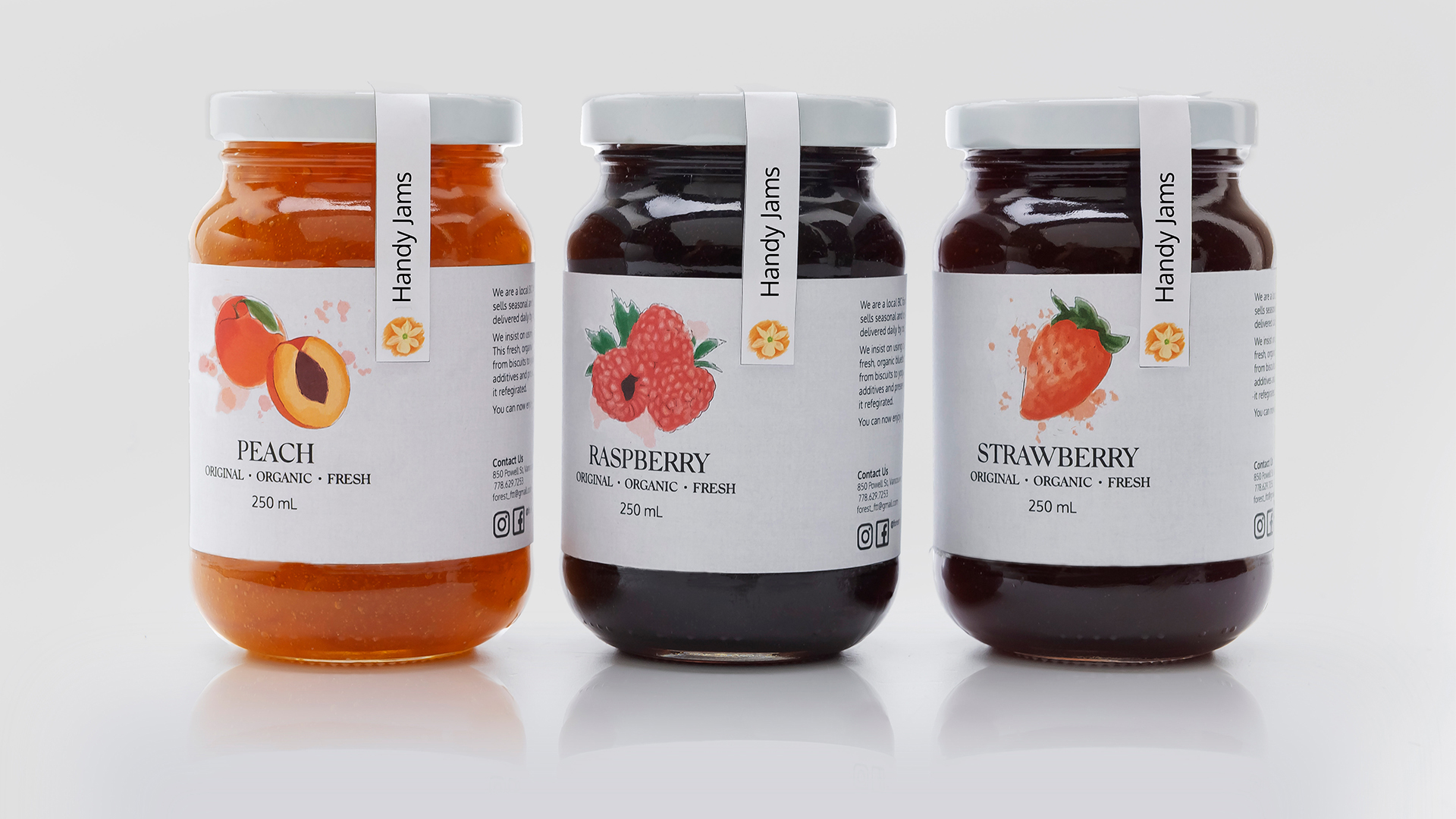 A display of 3 jars of peach, raspberry, and strawberry handmade jams for Handy Jams.