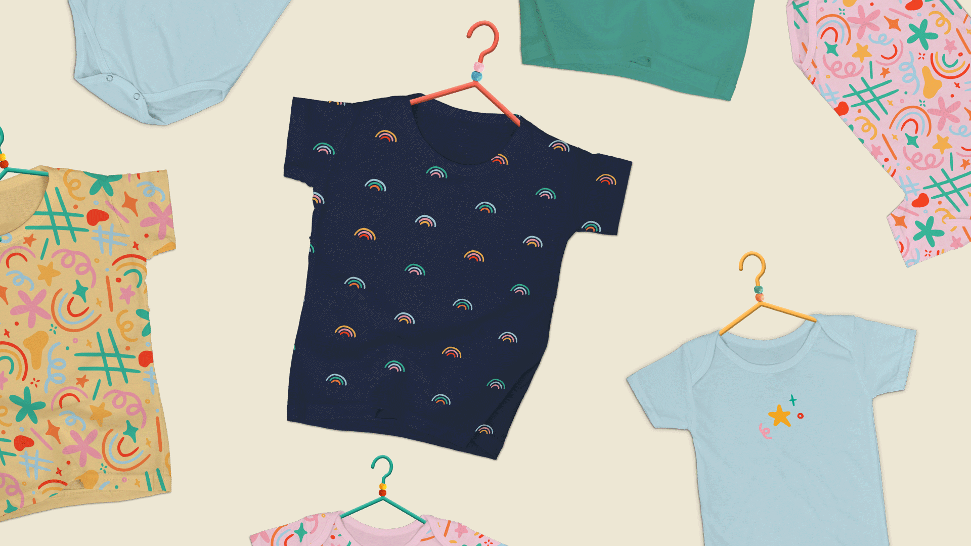 Children’s t-shirts and onesies randomly scattered on the page.