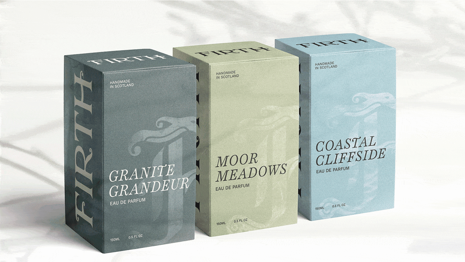 A gif cycling through three rectangular perfume boxes, Granite Grader, Coastal Cliffside, and Moor Meadows, set against light grey backgrounds, showing the back, left, and right sides of each package. Transitions to the matching perfume bottles displayed against a green bush.