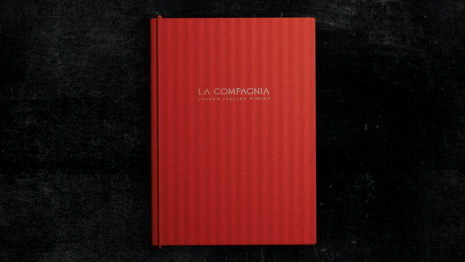 Looping GIF of a textured red "La Compagnia" Italian restaurant menu opening to reveal inner pages against a dark background.